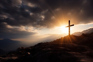 Cross on the rock with dramatic sunset sky background. Christian concept.