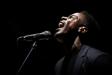 Black Male Singer Singing With Microphone In Front Of Dark Background Bokeh Style Background
