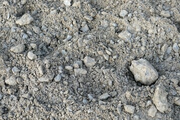 Close-up of a pile of crushed stone in the sand.