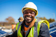 © Made360 - Happy African male engineer in hard hat at solar panel site professional usage in renewable energy and construction industry
