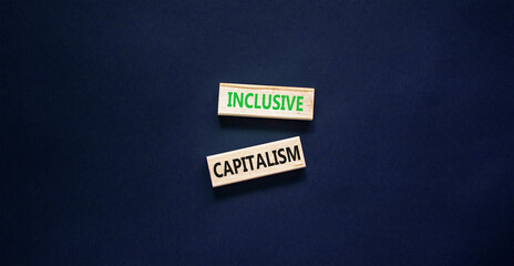 Inclusive capitalism symbol. Concept words Inclusive capitalism on beautiful wooden blocks. Beautiful black table black background. Business inclusive capitalism concept. Copy space.