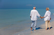 © Darren Baker - Happy Senior Couple Walking Holding Hands Tropical Beach