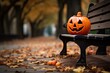 A scary pumpkin on a bench in an autumn park. Halloween story.