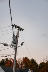 An electric pole against a grey sky in Maine, USA