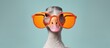 Portrait of a funny goose with yellow glasses isolated on blue background