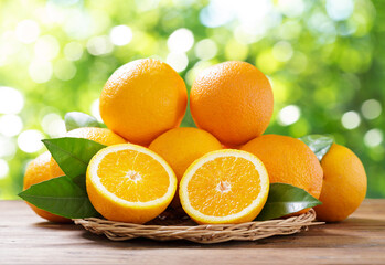 Wall Mural - fresh orange fruits with leaves on wooden table