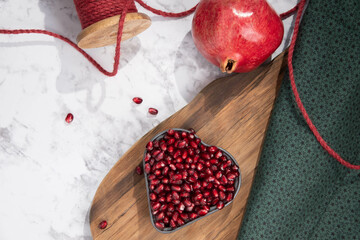 Wall Mural - Fresh pomegranate arils in a heart shaped bowl