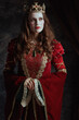 © Alliance - medieval queen in red dress with white makeup and crown