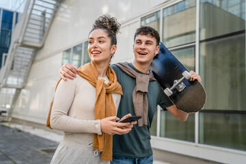 modern brother and sister or couple young man and woman walk outdoor