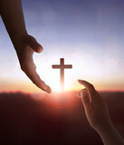 Fototapeta Zachód słońca - Jesus Christ reaching out to help human on cross background