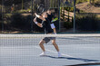 © Mat Hayward - Two adult men playing an intense game of tennis together on an outdoor court. The sport is fast and they are training during practice.