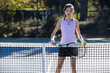 © Mat Hayward - Young female Asian tennis player outside on the court playing a game. The woman is athletic and healthy. Physical fitness is part of her active lifestyle.