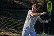© Mat Hayward - Athletic man on tennis court. The player is holding a racket or racquet in a match and his ready to compete.