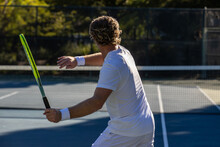 Athletic Man On Tennis Court. The Player Is Holding A Racket Or Racquet In A Match And His Ready To Compete.