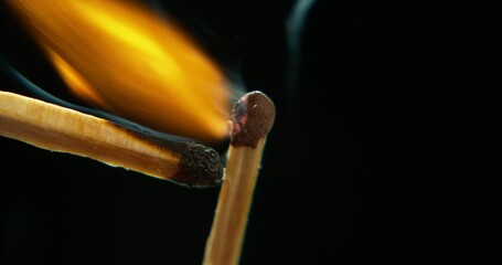 Wall Mural - match, smoke and lighting fire on a black background in studio for light or warmth in winter closeup