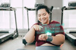 healthy fat women happy using smart wearable science technology device fitness trackers display hologram body insight activity information.