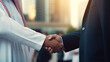 Arab businessman shaking hands with businessman.