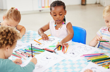 Poster - Black kid, pencil and drawing for homework in classroom with creative, art or project for picture. Little girl, serious look and choice of color for learning, education or development of motor skills