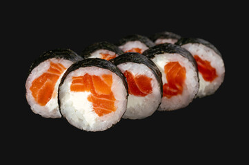 Wall Mural - sushi roll with salmon isolated on black  background.