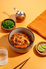 Wall Mural - asian noodles with chicken and vegetables. menu. orange background