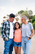© Raul Mellado - vertical photo looking at camera of a father, mother and daughter smiling happy in the countryside, concept of active tourism in nature and family outdoors activities, copy space for text
