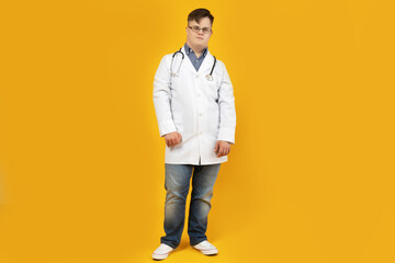 Wall Mural - A boy with Down syndrome in a doctor's uniform