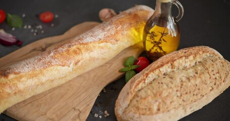 Canvas Print - baguette bread on a wooden cutting board at domestic kitchen close-up