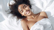 © Keitma - Black African American woman 20 yo in a white clothes laying down on white bed with white blanket, happily sleeping