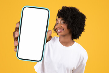 Poster - black lady showing large blank smartphone screen over yellow backdrop