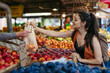 © Westend61 - Woman shopping for fresh fruits and vegetables at the city market