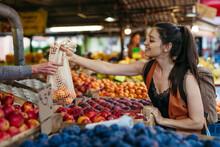 Woman Shopping For Fresh Fruits And Vegetables At The City Market