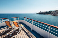 France, Haute-Corse, Deck Chairs On Bow Of Ferry Sailing Toward Coast Of Corsica Island