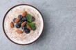 Tasty wheat porridge with milk, blueberries and almonds in bowl on gray table, top view. Space for text
