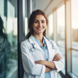 © Ren - Beautiful smiling female doctor standing in white coat in hospital