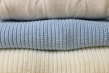 Wall Mural - Stack of casual warm sweaters as background, closeup view