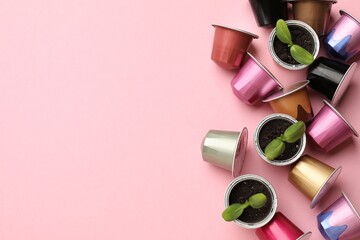 Wall Mural - Coffee capsules and seedlings on pink background, flat lay. Space for text