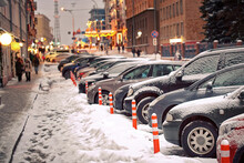 Cars Parked Close To Flexible Plastic Warning Post. Cars Parked At Parking Lot Along City Road In Winter Season. Heavy Snowfall Or Snowstorm In The City. Cars Covered With Snow