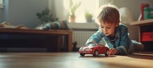 Cute Little Child Boy Playing With Red Big Car Toy Sitting On The Floor In His Play Room