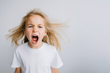 Portrait Of A Cute Kid, Girl, Screaming, White And Neutral Teeshirt And Background, Fear, Anger