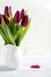 Bunch of tulips in a white vase copy space