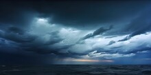 Nature Fury. Dramatic Storm Unleashing Power Over Darkened Ocean Featuring Stormy Sky Rain Laden Clouds And Threatening Beauty Of Waves Crashing Against Horizon