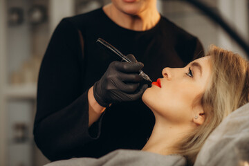 Canvas Print - Permanent lip makeup. Microblading lip tattoo with special coloring pigment corrects lip color in cosmetology clinic.