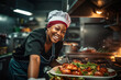 © arhendrix - African American female chef having fun while preparing food in the kitchen at restaurant.