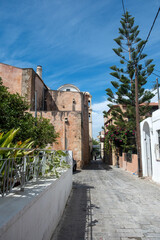 Wall Mural - Crete island, Chania Old Town, Greece. St. Nicholas Church, araucaria heterophylla, alley. Vertical