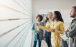 © Flamingo Images - Diverse businesspeople having a brainstorming session with adhesive notes in an office