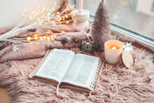 Open Bible In Cozy Pink Winter Home Morning Atmosphere