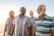 © A Denny Syahputra - group of senior men walking on the beach happily