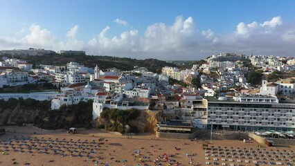 Wall Mural - Aerial view of seaside Albufeira with wide beach and white architecture, Algarve, Portugal. Wide sandy beach in city of Albufeira, Algarve, Portugal. Aerial view of Albufeira town, Algarve, Portugal.