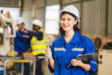 Fototapeta  - Female engineer using laptop computer for safety control checks or manufacturing maintenance work in factory building or construction site. woman engineer inspector working in industry product line