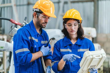 Wall Mural - Female engineer using laptop computer for safety control checks or manufacturing maintenance work in factory building or construction site. woman engineer inspector working in industry product line